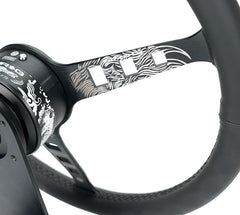NRG Innovations Reinforced Steering Wheel - Fuguz x NRG collaboration 1.5" Deep, 5mm matte black spoke, 380mm Sport Steering Wheel Black leather w/ black stitching iconic episode 2 laser engraving RST-380SK-EP2